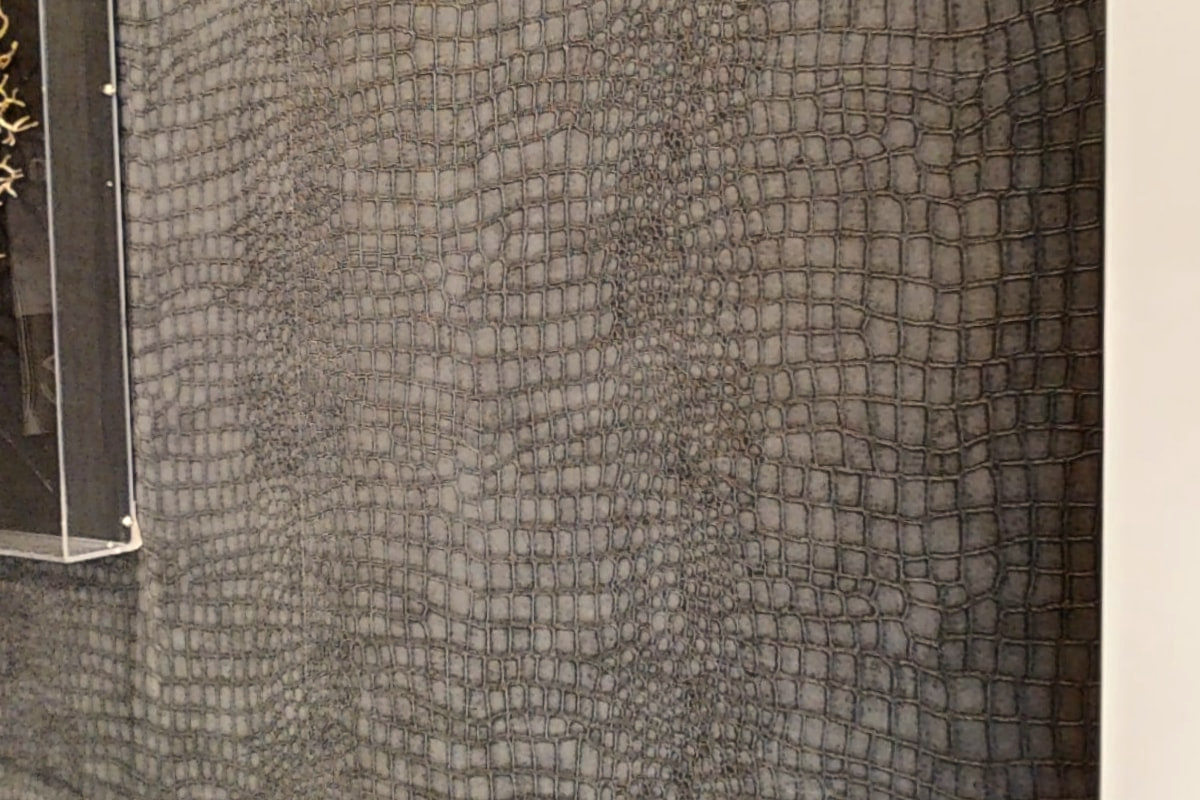 A textured grey wallcovering in the waiting area at Shirland Dental Practice