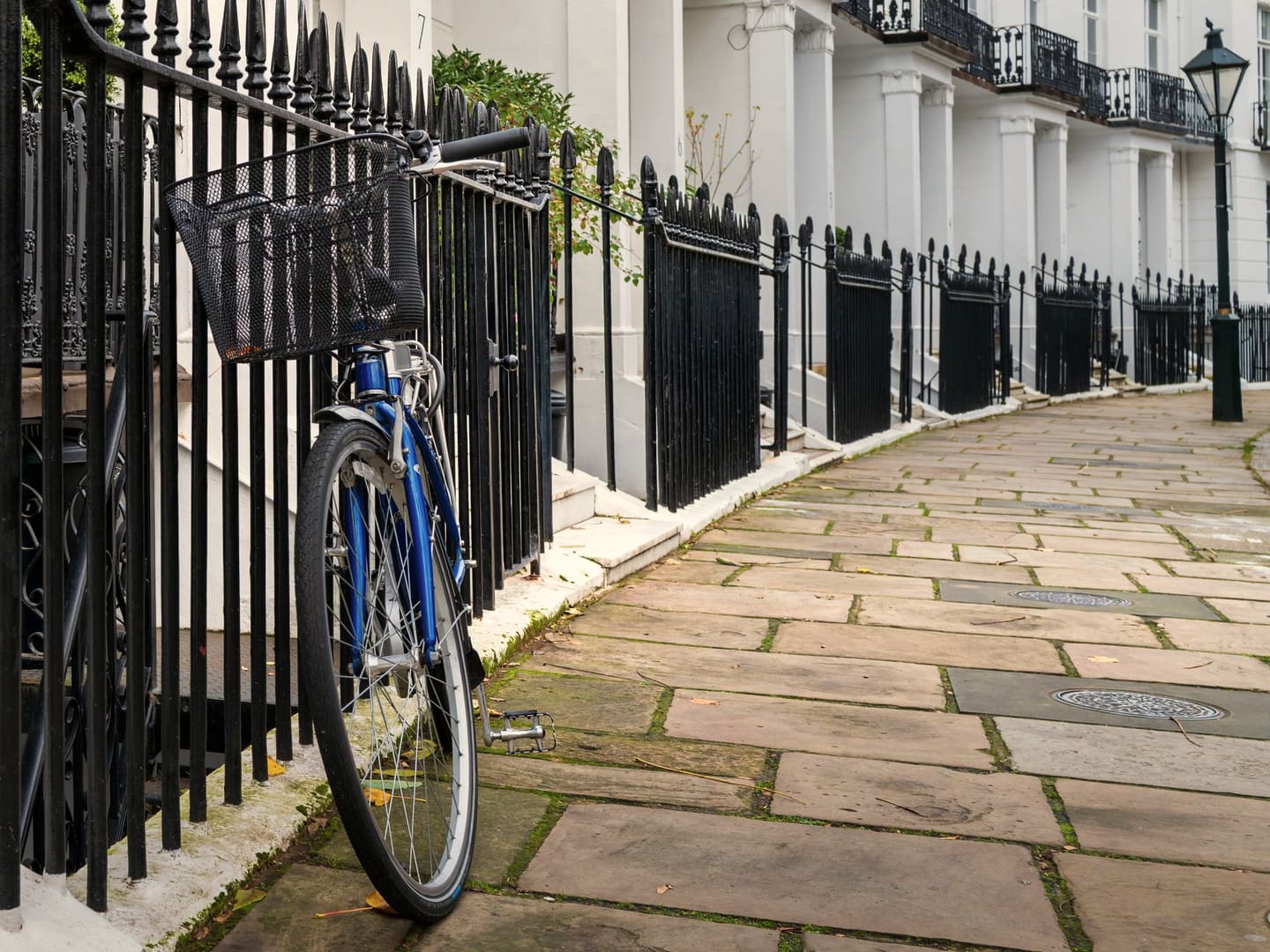 Stucco townhouses with iron railings near Kilburn Park