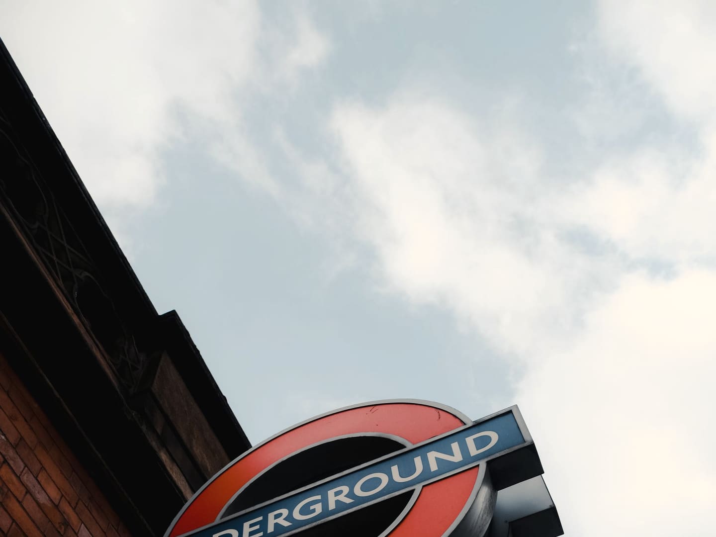 London Underground roundel on a brick station wall