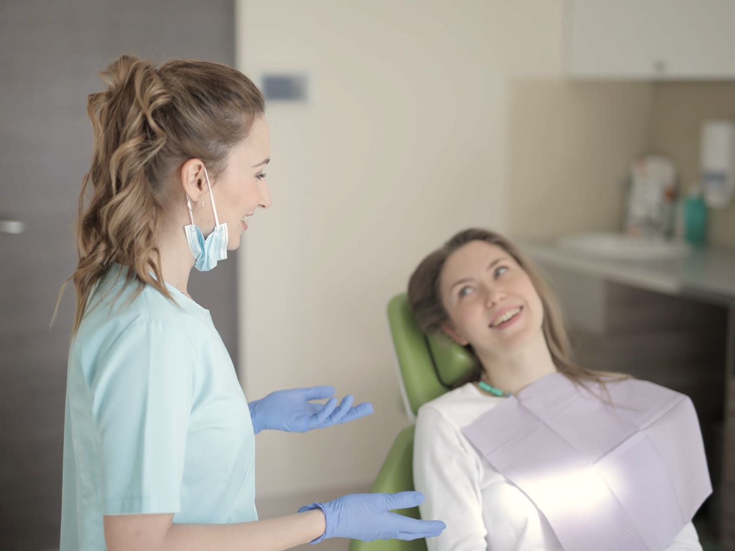 Dentist talking a new patient through their first check-up