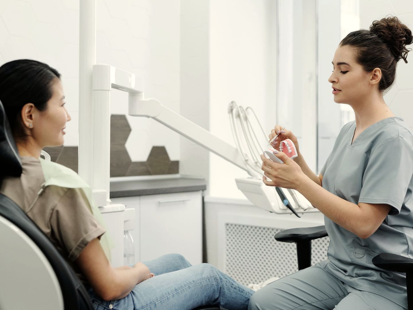 Surgeon explaining a procedure with a model of the jaw